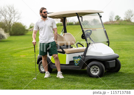 Handsome man making training on the golf course standing near car Handsome man making training on the golf course standing near car 115713788