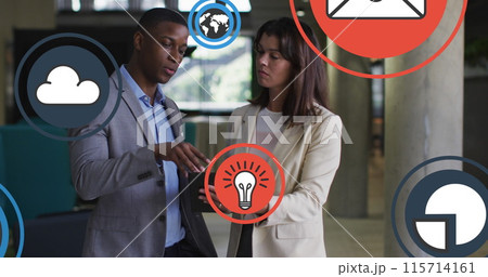 Image of media icons over diverse business people in office Image of media icons over diverse business people in office 115714161