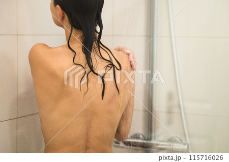 Waist up picture of a womans back in the shower 115716026