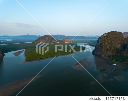Amazing mountains abundant mangrove forest,Aerial view of forest trees in sunrise or sunset sky over sea 115717138