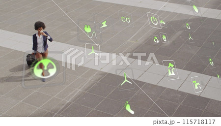Image of icons and business data over african american woman using smartphone 115718117
