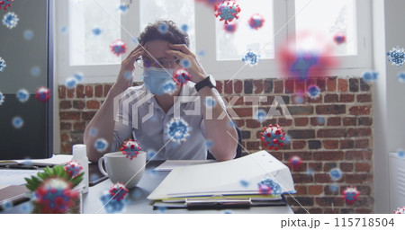 Image of covid 19 cells over stressed man in face mask, holding his head in office Image of covid 19 cells over stressed man in face mask, holding his head in office 115718504