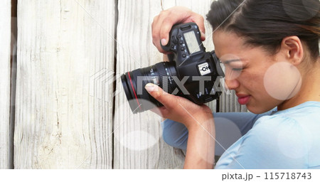 White spots against close up of caucasian female photographer clicking pictures with digital camera 115718743