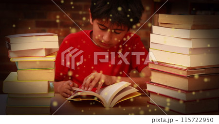 Image of glowing spots over asian boy reading book 115722950