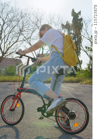 spring is comming concept with happy and cheerful feeling of asian woman riding bicycle spring is comming concept with happy and cheerful feeling of asian woman riding bicycle 115723878