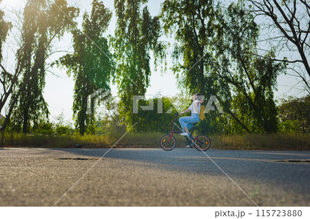 spring is comming concept with happy and cheerful feeling of asian woman riding bicycle spring is comming concept with happy and cheerful feeling of asian woman riding bicycle 115723880