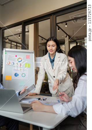 Business Team Collaboration on Data Analysis in Modern Office Setting with Charts and Laptops Business Team Collaboration on Data Analysis in Modern Office Setting with Charts and Laptops 115726713
