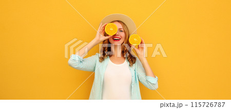 Summer portrait of happy joyful young woman with slices of orange fruit, cheerful girl smiles in hat Summer portrait of happy joyful young woman with slices of orange fruit, cheerful girl smiles in hat 115726787