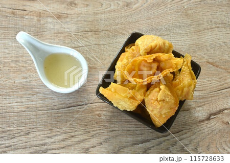 crispy fried dumpling paste stuffed chop pork and shrimp dipping sweet chili plum sauce on cup crispy fried dumpling paste stuffed chop pork and shrimp dipping sweet chili plum sauce on cup 115728633
