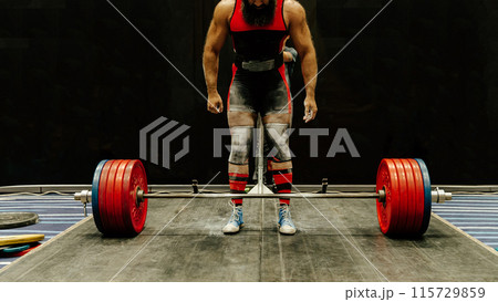 indian powerlifter stand in front barbell with record weight at deadlift competition indian powerlifter stand in front barbell with record weight at deadlift competition 115729859
