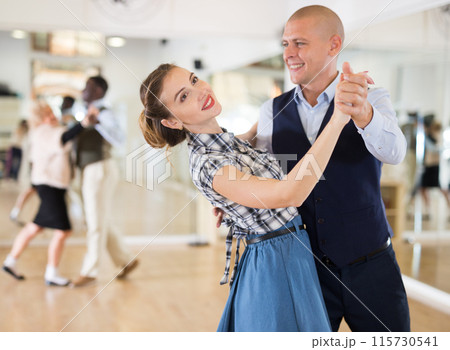 Man and woman dancing waltz in studio Man and woman dancing waltz in studio 115730541
