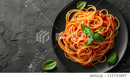 Dark plate with Italian spaghetti on a dark background. 115731667