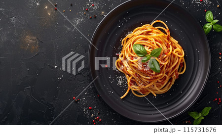 Dark plate with Italian spaghetti on a dark background. 115731676