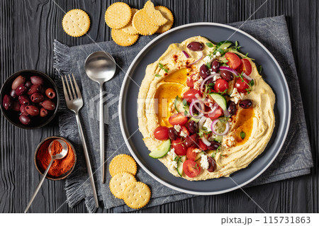 Greek hummus with veggies, olives, feta on plate 115731863