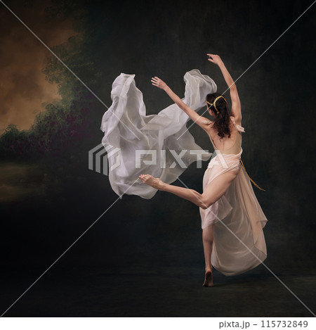 Ethereal Motion. Moment of serene beauty as dancer appears to float effortlessly in air against vintage studio background. 115732849
