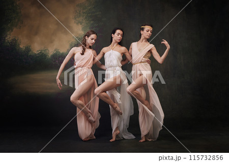 Group portrait of beautiful women in flowing dresses dancing synchronously against vintage studio background. 115732856