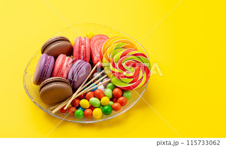 Various colorful candies, lollipops, and macaroons Various colorful candies, lollipops, and macaroons 115733062