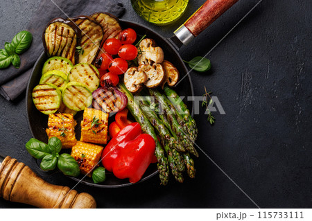 Assorted grilled vegetables on a frying pan, showcasing a colorful and healthy meal 115733111