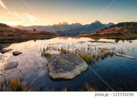 Landscape of sunrise shines over Lac Guichard with Arves massif and lake reflection in autumn at French Alps, France 115733230