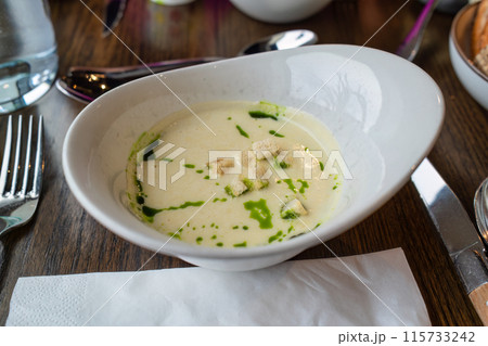 Truffle mushroom soup with spring onion sauce in ceramic bowl Truffle mushroom soup with spring onion sauce in ceramic bowl 115733242