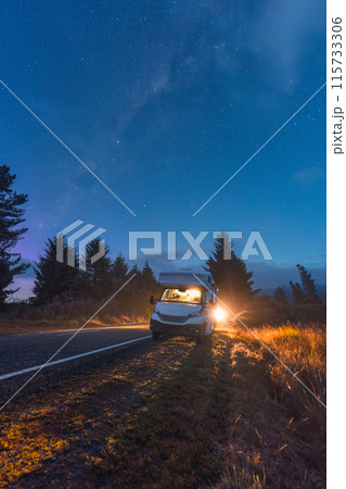Milky way with starry in night sky and motorhome parked on roadside 115733306
