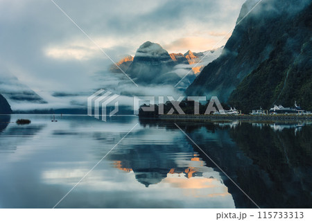 Milford Sound with waterfall in foggy on the lake at Fjordland national park, New Zealand Milford Sound with waterfall in foggy on the lake at Fjordland national park, New Zealand 115733313