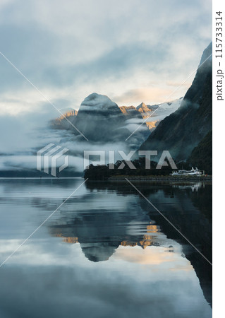 Milford Sound with waterfall in foggy on the lake at Fjordland national park, New Zealand Milford Sound with waterfall in foggy on the lake at Fjordland national park, New Zealand 115733314