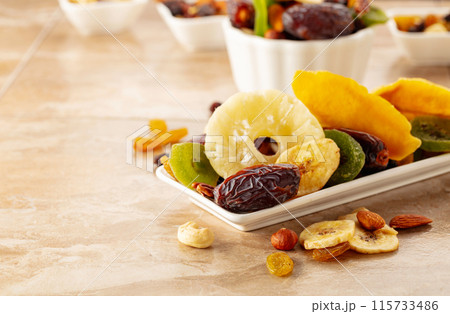 Dried tropical fruits with various nuts and raisins. 115733486