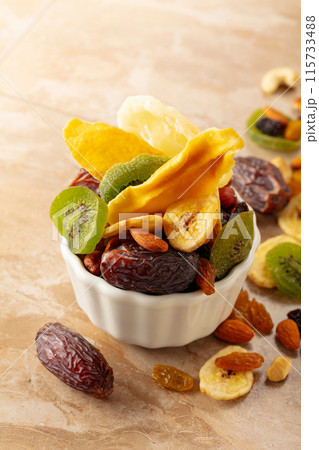Dried tropical fruits with various nuts and raisins. 115733488