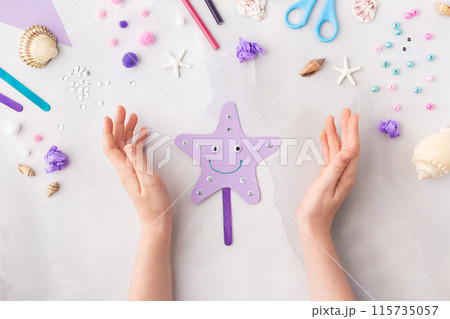 Violet paper sea star summer idea for kids craft in kindergarten hands ocean's day Violet paper sea star summer idea for kids craft in kindergarten hands ocean's day 115735057