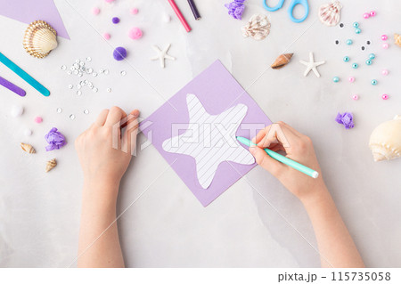 Violet paper sea star summer idea for kids craft in kindergarten hands ocean's day Violet paper sea star summer idea for kids craft in kindergarten hands ocean's day 115735058
