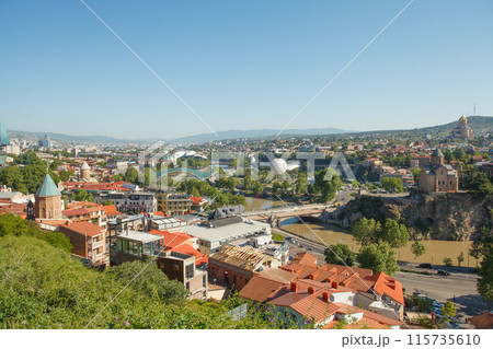 Landscape of old town Tbilisi and river on the background of blue sky and green mountains Landscape of old town Tbilisi and river on the background of blue sky and green mountains 115735610