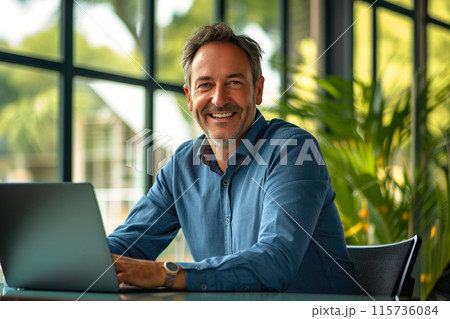 Professional Man Smiling in Sunlit Office Setting 115736084
