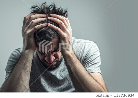 Dark Moments: Man Holding Head in Painful Reflection Dark Moments: Man Holding Head in Painful Reflection 115736934
