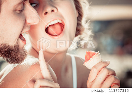 young couple eating ice cream outdoor young couple eating ice cream outdoor 115737316