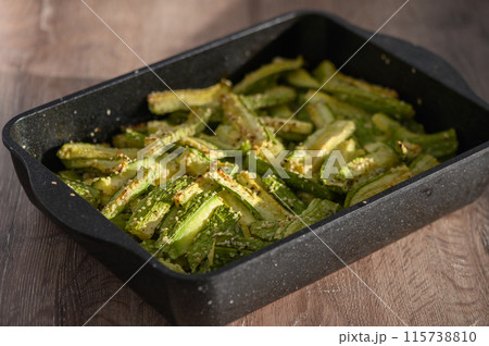 zucchini baked in the oven on a wooden table 115738810