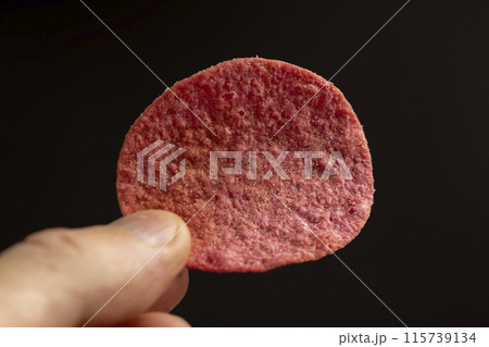 adding red dye to potato chips adding red dye to potato chips 115739134