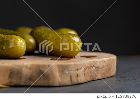 green cucumbers pickled in vinegar 115739276