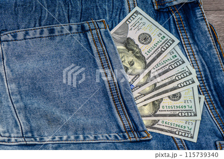 One hundred dollar banknote money in pocket jeans pants background texture. 100 dollar bill close up 2 115739340