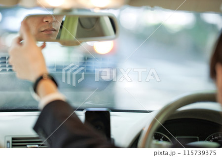 ハンドルを握るスーツの若い男性 115739375