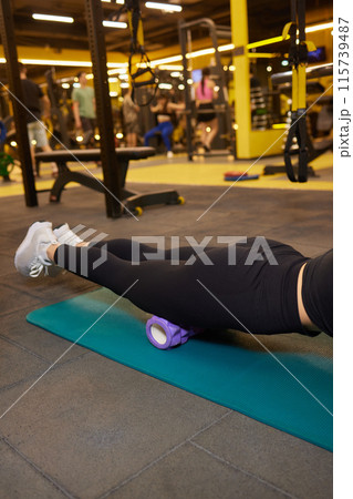 Leg massage with foam roller helps relax muscles, recover, relieve tightness, and prevent injuries Leg massage with foam roller helps relax muscles, recover, relieve tightness, and prevent injuries 115739487