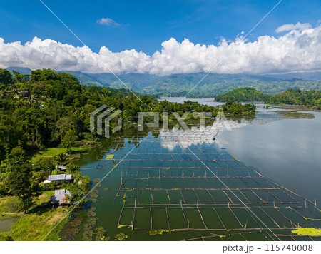 Aerial view of fish farm in Lake Sebu and rainforest, green trees. Mindanao, Philippines. Summer and travel destinations. Aerial view of fish farm in Lake Sebu and rainforest, green trees. Mindanao, Philippines. Summer and travel destinations. 115740008
