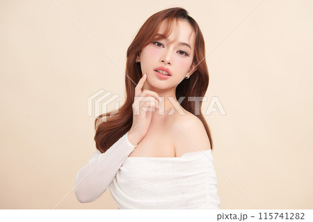 Beautiful young asian woman with clean fresh skin on beige background, Face care, Facial treatment, Cosmetology, beauty and spa, Asian women portrait. Beautiful young asian woman with clean fresh skin on beige background, Face care, Facial treatment, Cosmetology, beauty and spa, Asian women portrait. 115741282