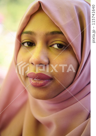 Close up Portrait of a Joyful Middle Eastern Hijabi 115741640