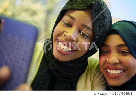Middle Eastern Muslim Women Capturing Selfies in Serene Surroundings Middle Eastern Muslim Women Capturing Selfies in Serene Surroundings 115741661