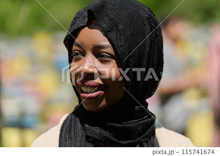 Joyful Middle Eastern Muslim Woman in Hijab Smiling Brightly in a Natural Apiary Joyful Middle Eastern Muslim Woman in Hijab Smiling Brightly in a Natural Apiary 115741674