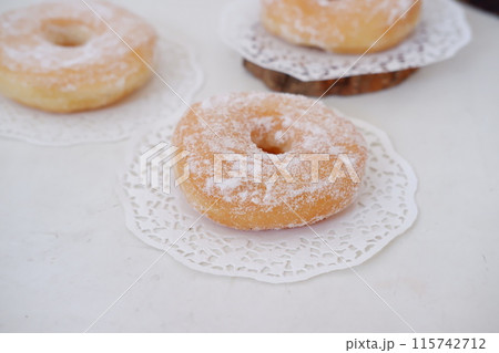 donuts with powdered sugar on top as a background donuts with powdered sugar on top as a background 115742712
