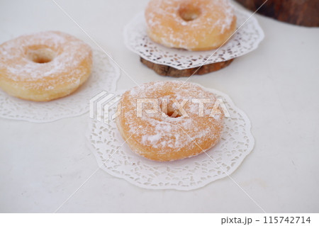 donuts with powdered sugar on top as a background donuts with powdered sugar on top as a background 115742714