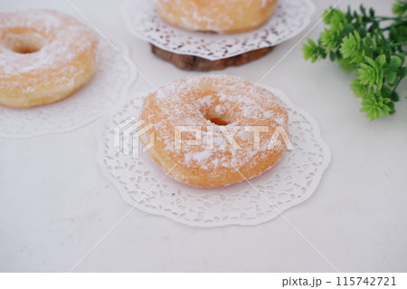 donuts with powdered sugar on top as a background donuts with powdered sugar on top as a background 115742721