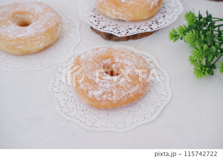 donuts with powdered sugar on top as a background donuts with powdered sugar on top as a background 115742722